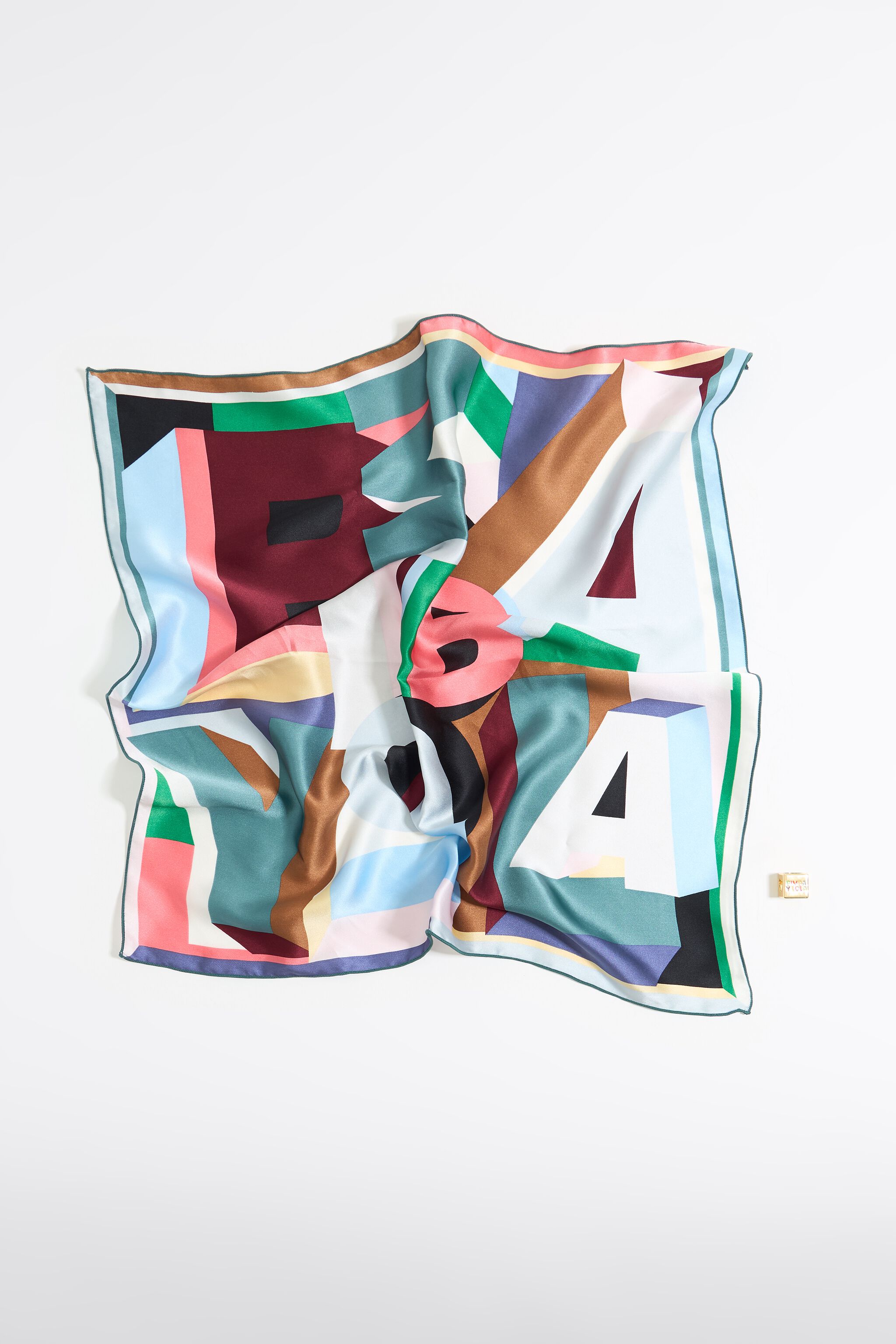 Geometric logo and metal dice scarf charm