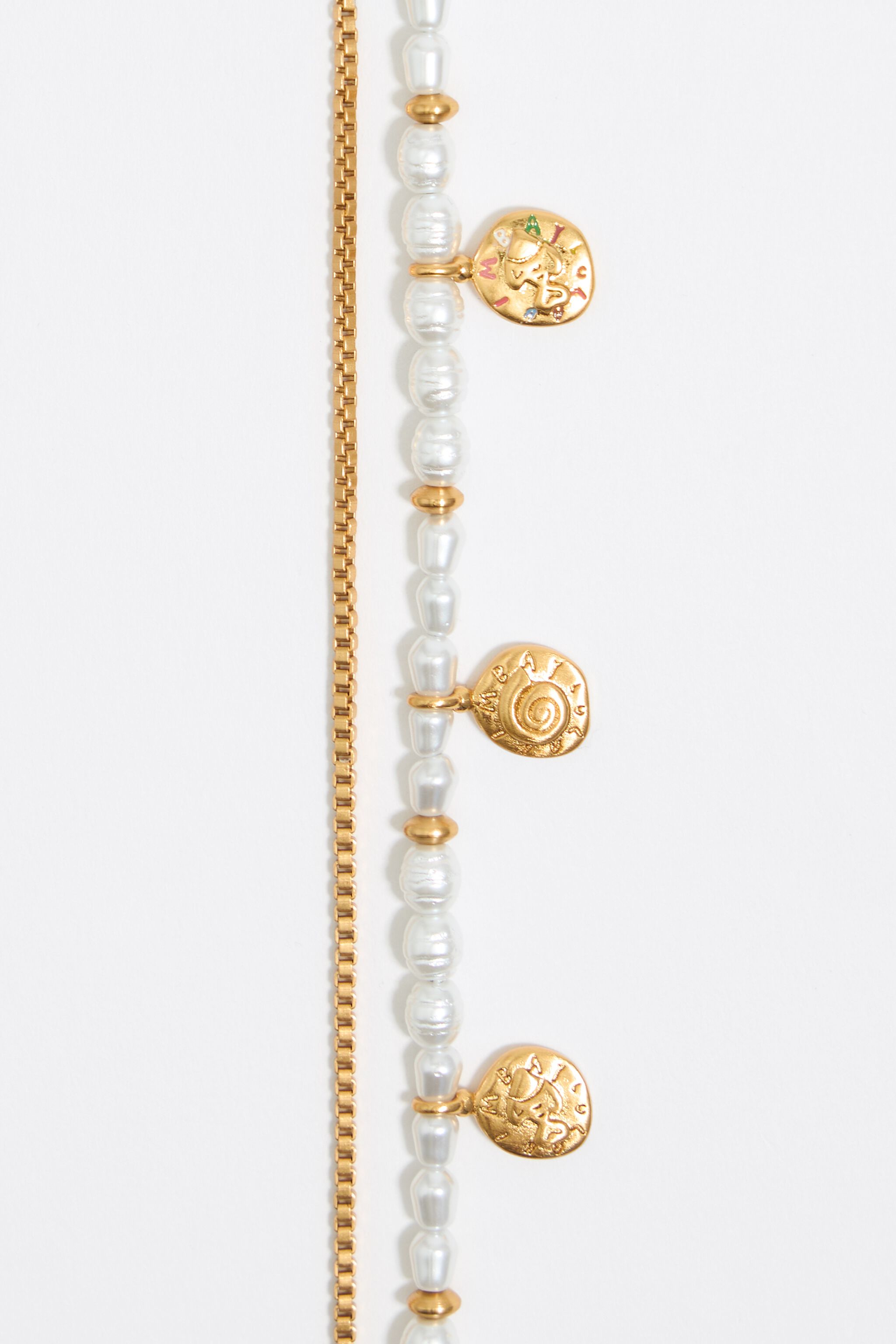 Gold coin logo and pearl necklace