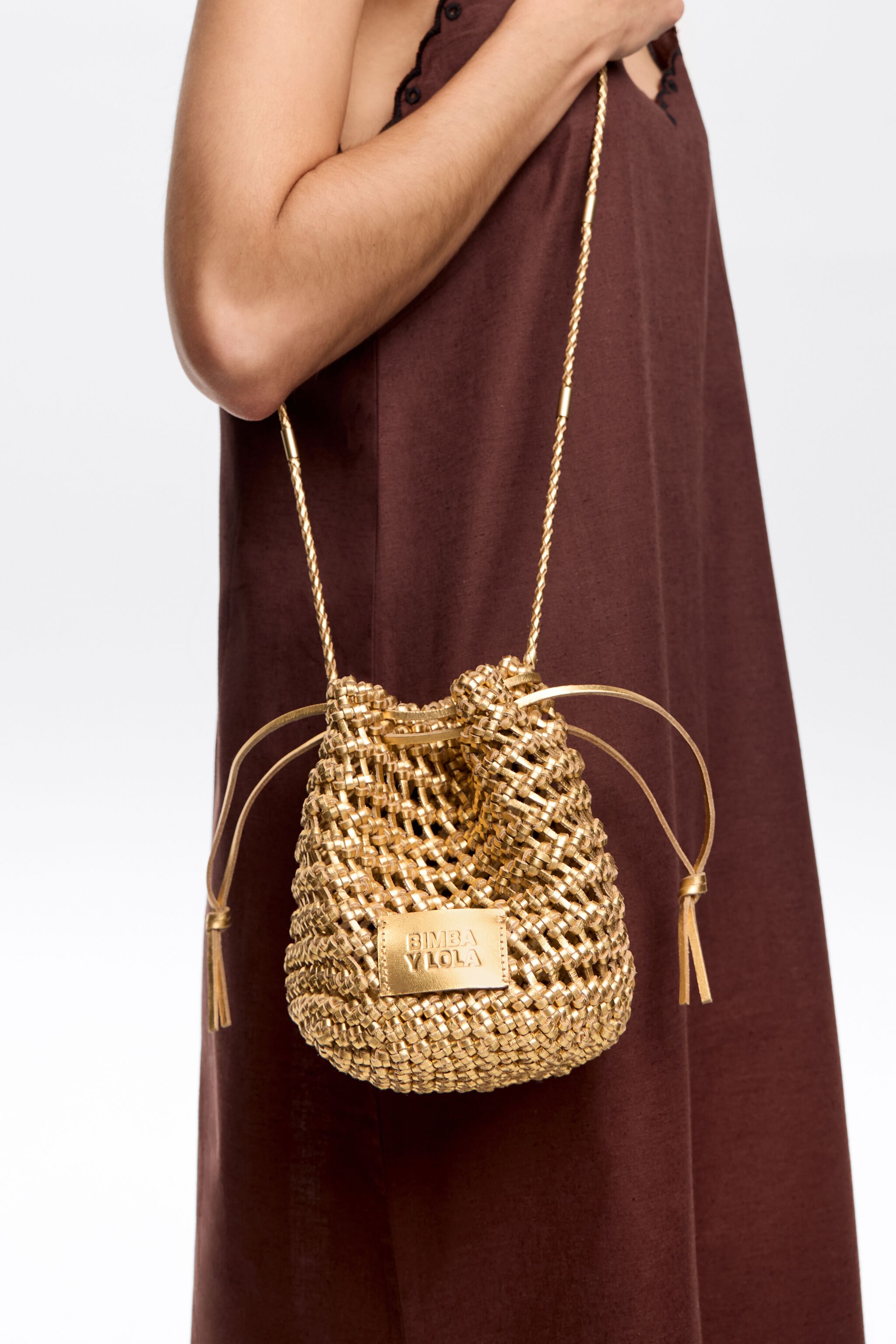 Small gold plaited leather bucket bag
