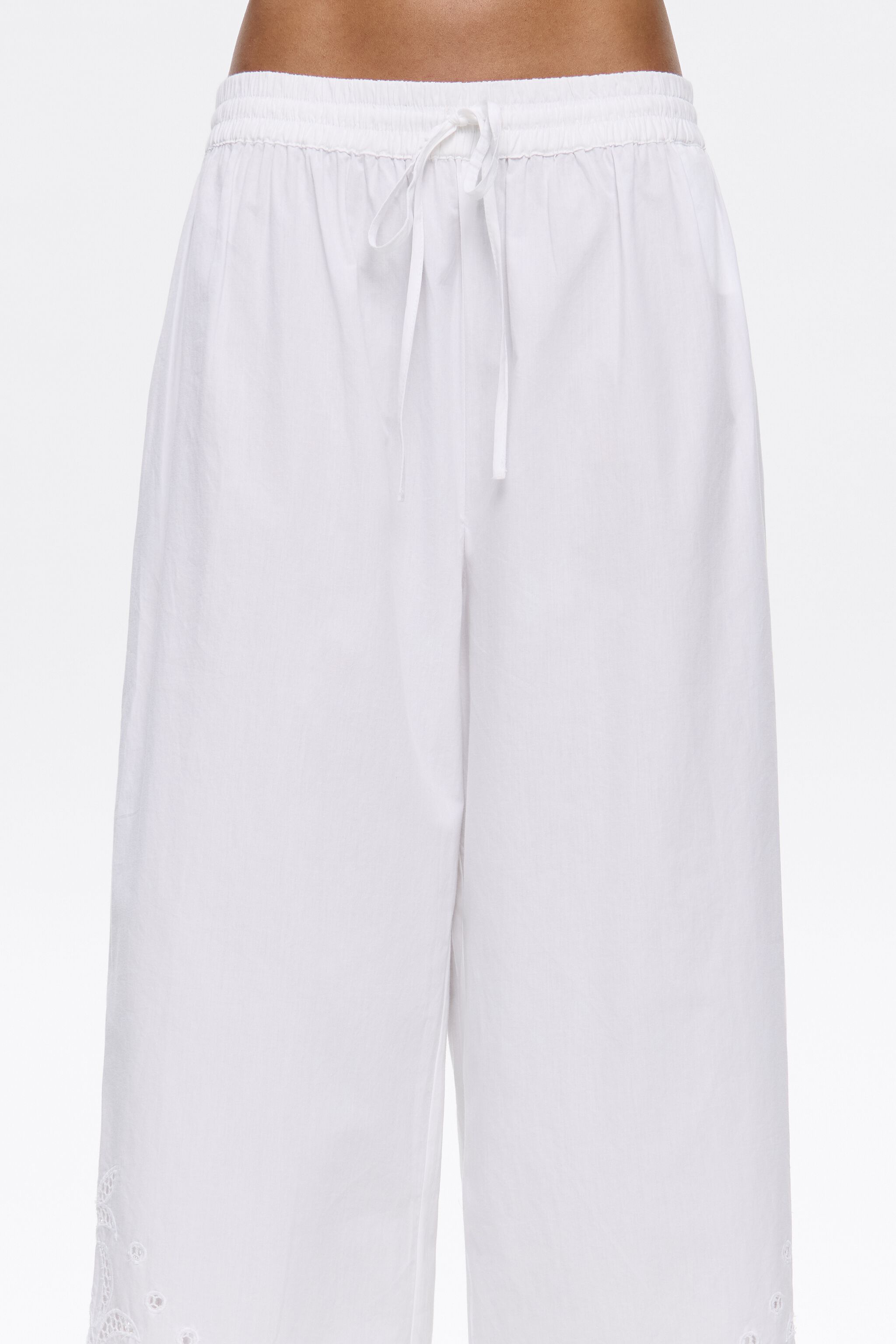 White embroidered jogger trousers