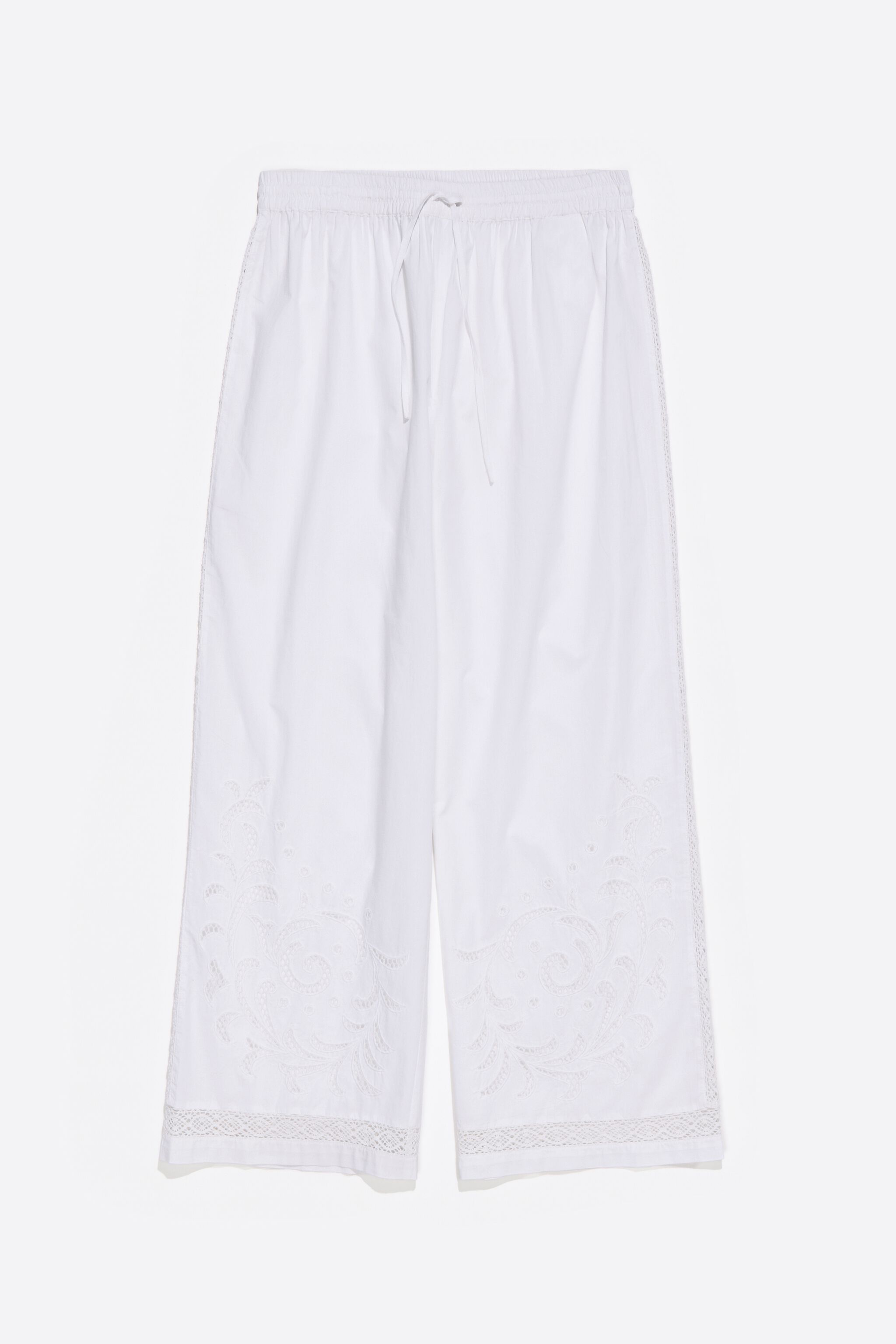 White embroidered jogger trousers