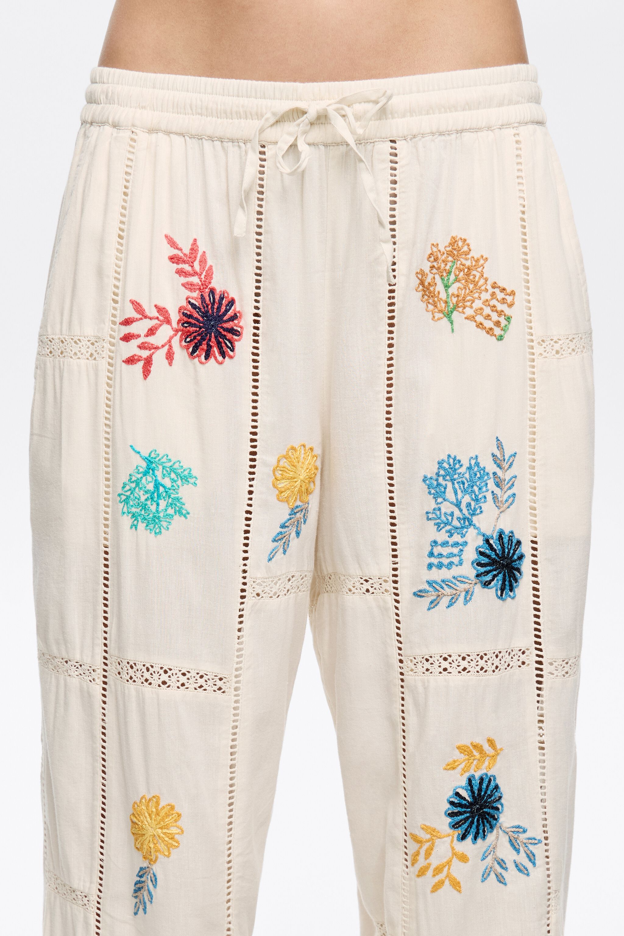 Cream jogger trousers with multicolor embroidery