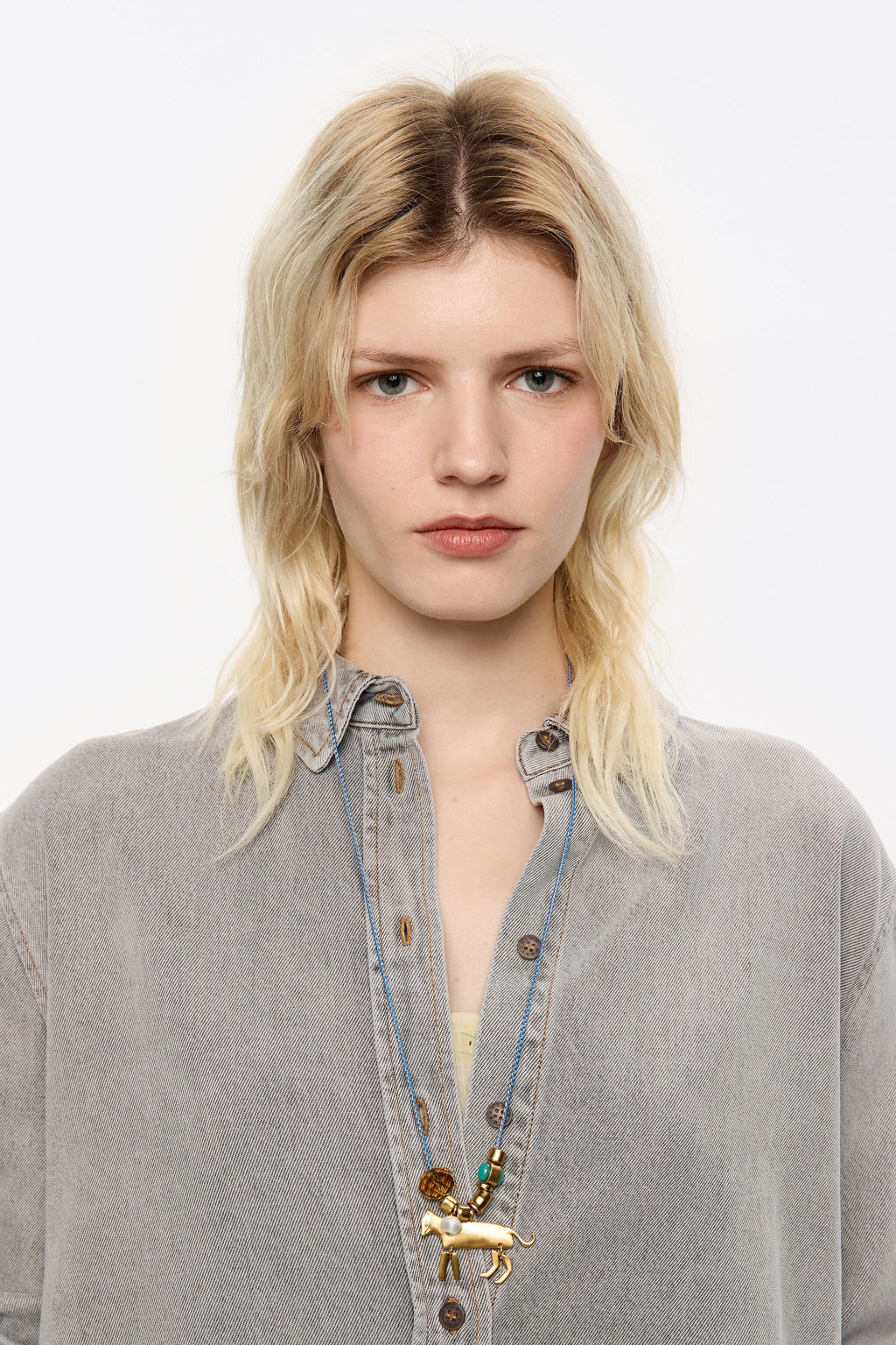 Long plaited cord necklace with gold-tone metal motifs