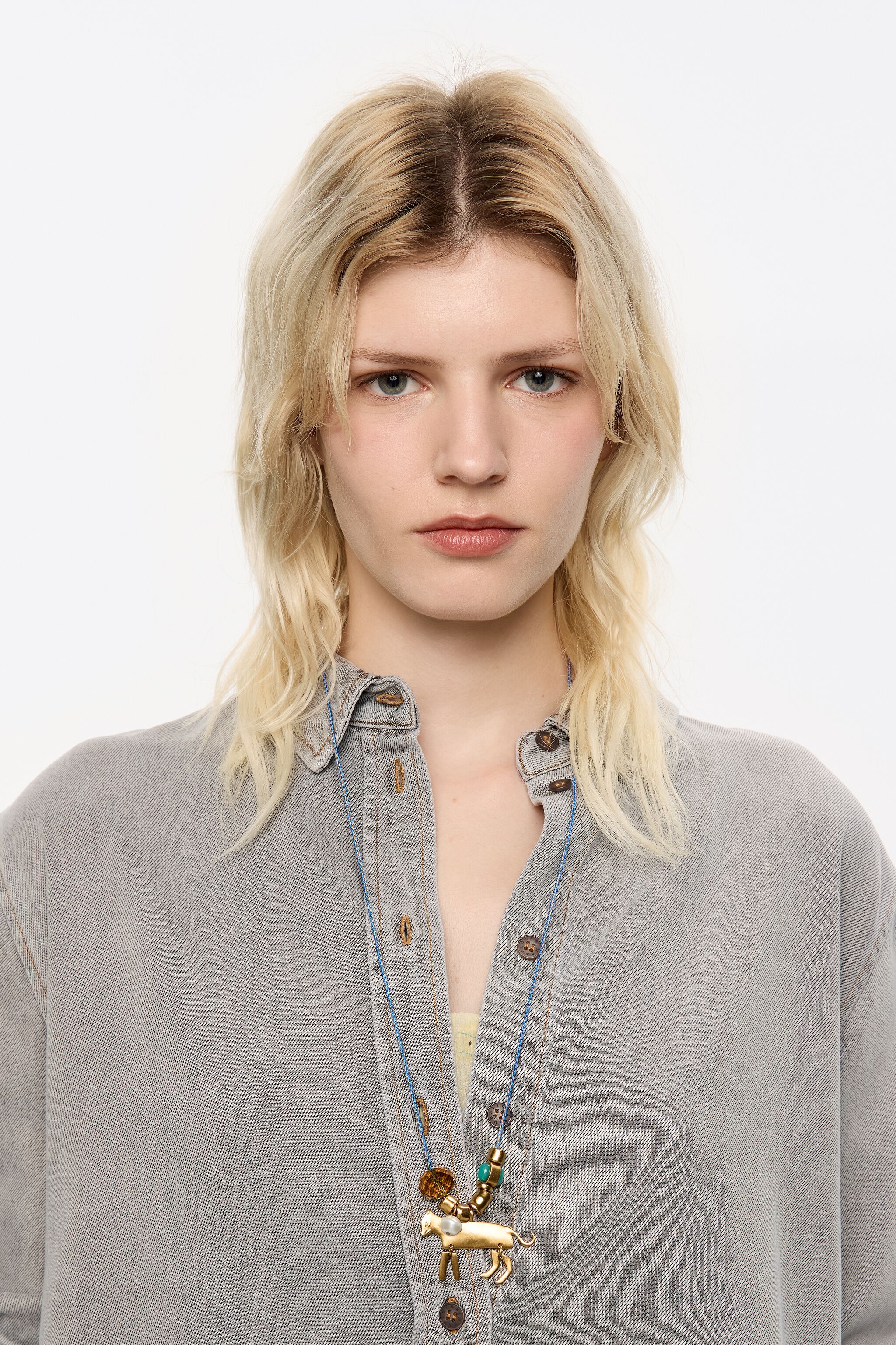 Long plaited cord necklace with gold-tone metal motifs