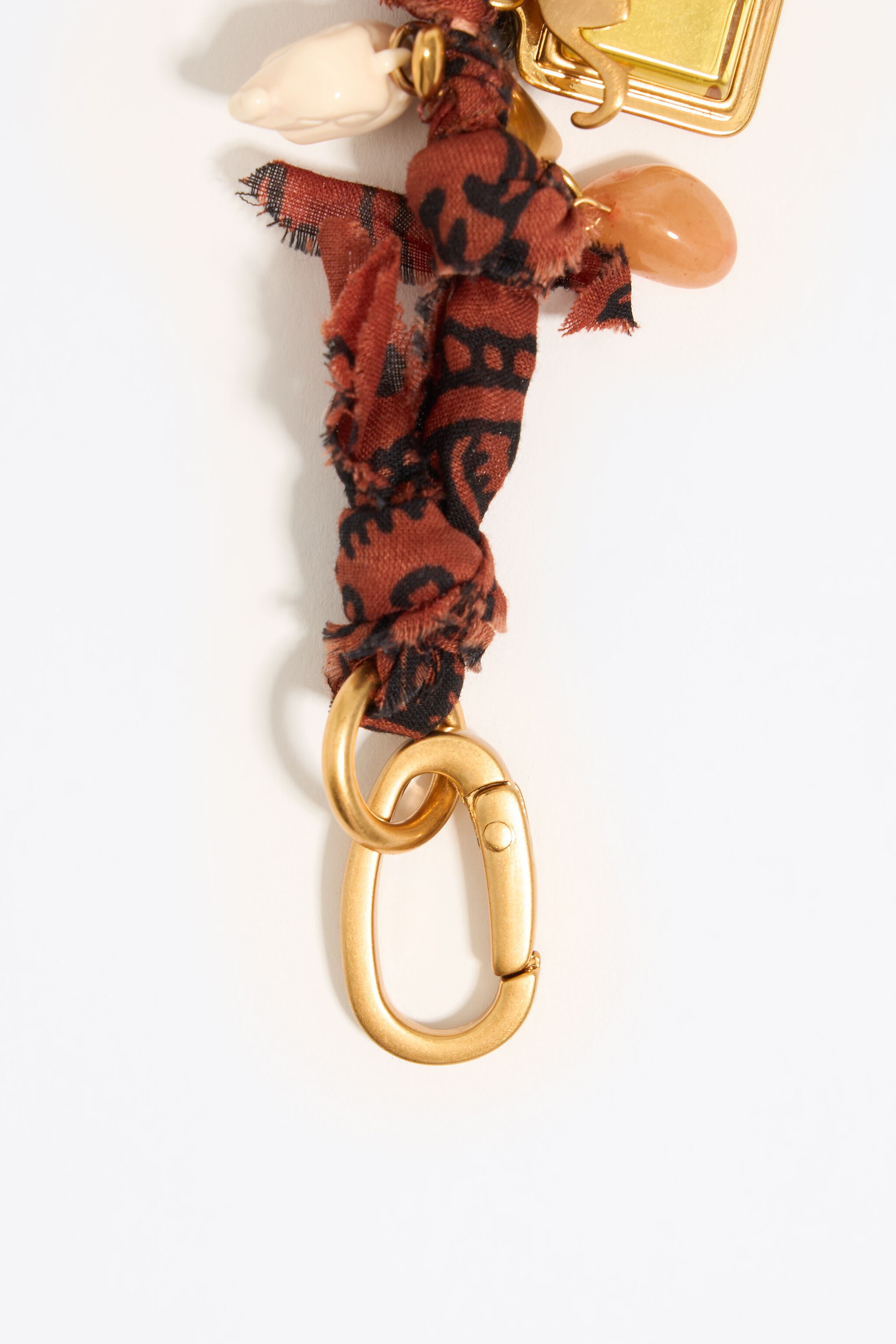 Plaited fabric bracelet with gold-tone metal pieces